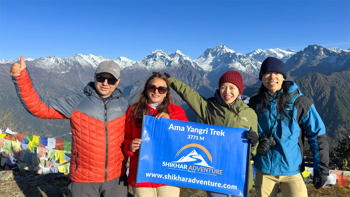 Shikhar Adventure trekking group at Ama Yangri summit 3,771 meters with prayer flags and mountain views