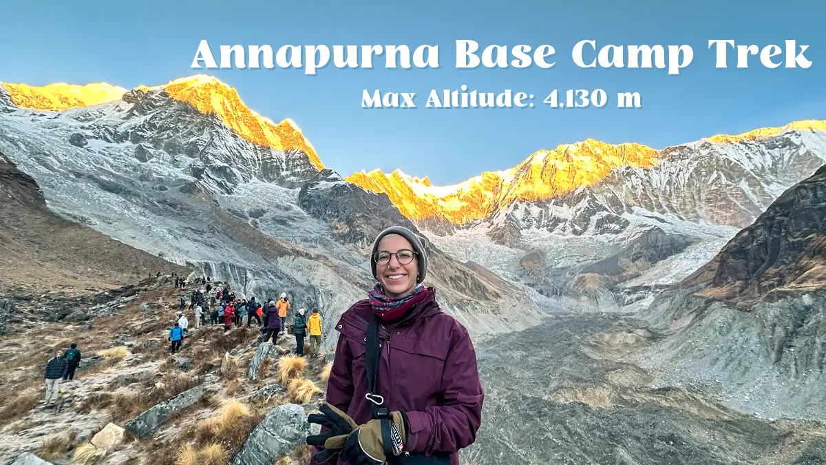 Trekkers at Annapurna Base Camp surrounded by Himalayan peaks at sunrise