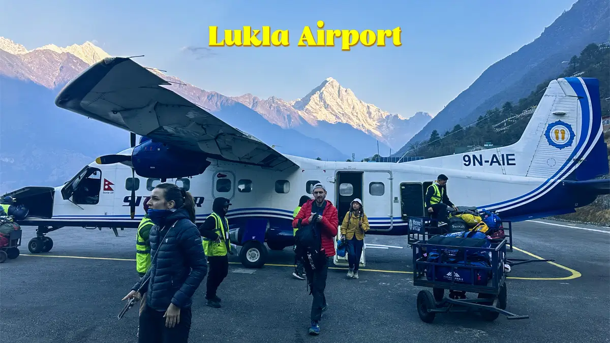 Trekker stepping out of the plane at Lukla Airport, beginning the Everest Base Camp trek