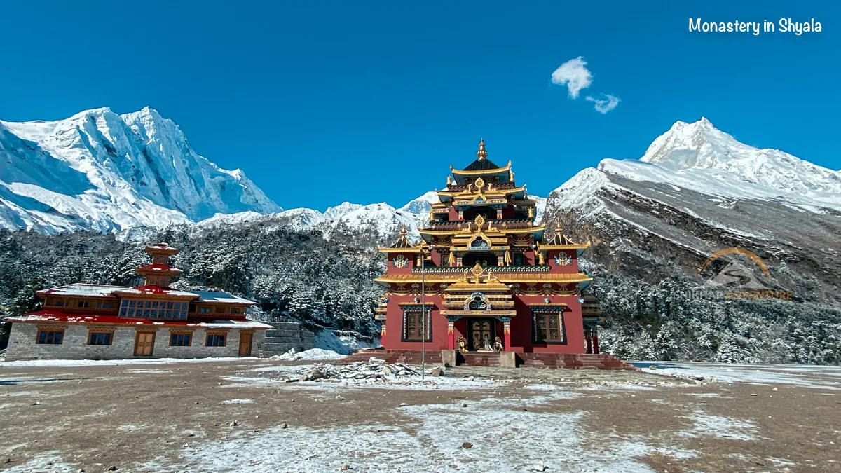 Traditional Shyala Monastery with mountain backdrop on the Manaslu Trek route