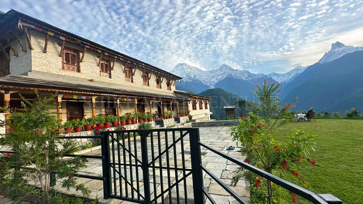 Annapurna Luxury Lodge nestled in the hills with views of snow-capped mountains and lush surroundings.