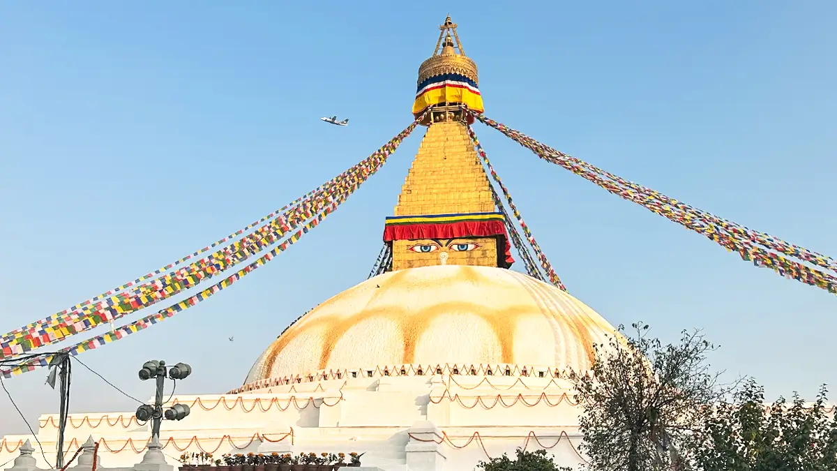 Boudhanath Stupa in Kathmandu, Nepal with prayer flags and pilgrims