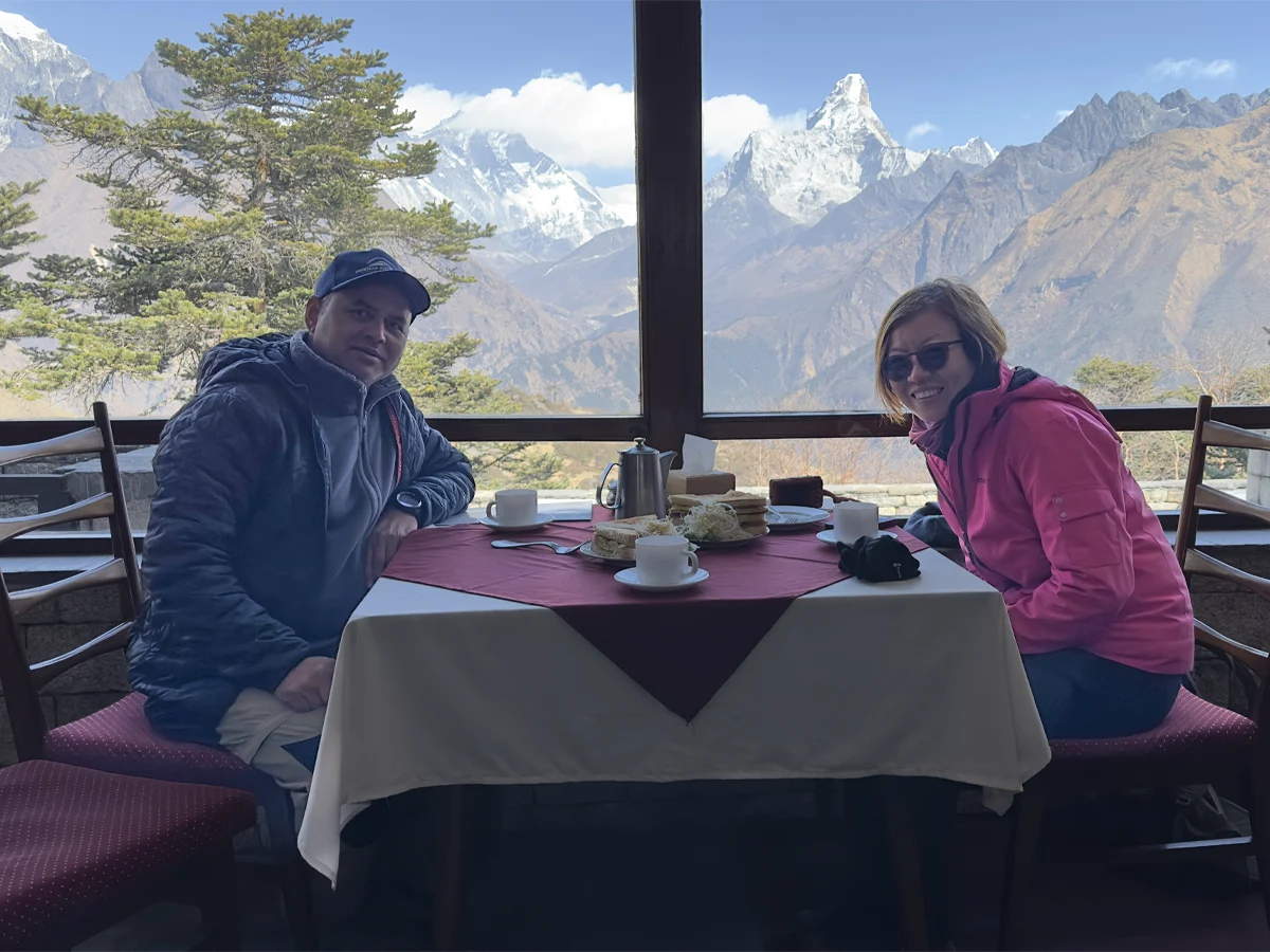 Trekkers relaxing at Hotel Everest View with mountain panorama
