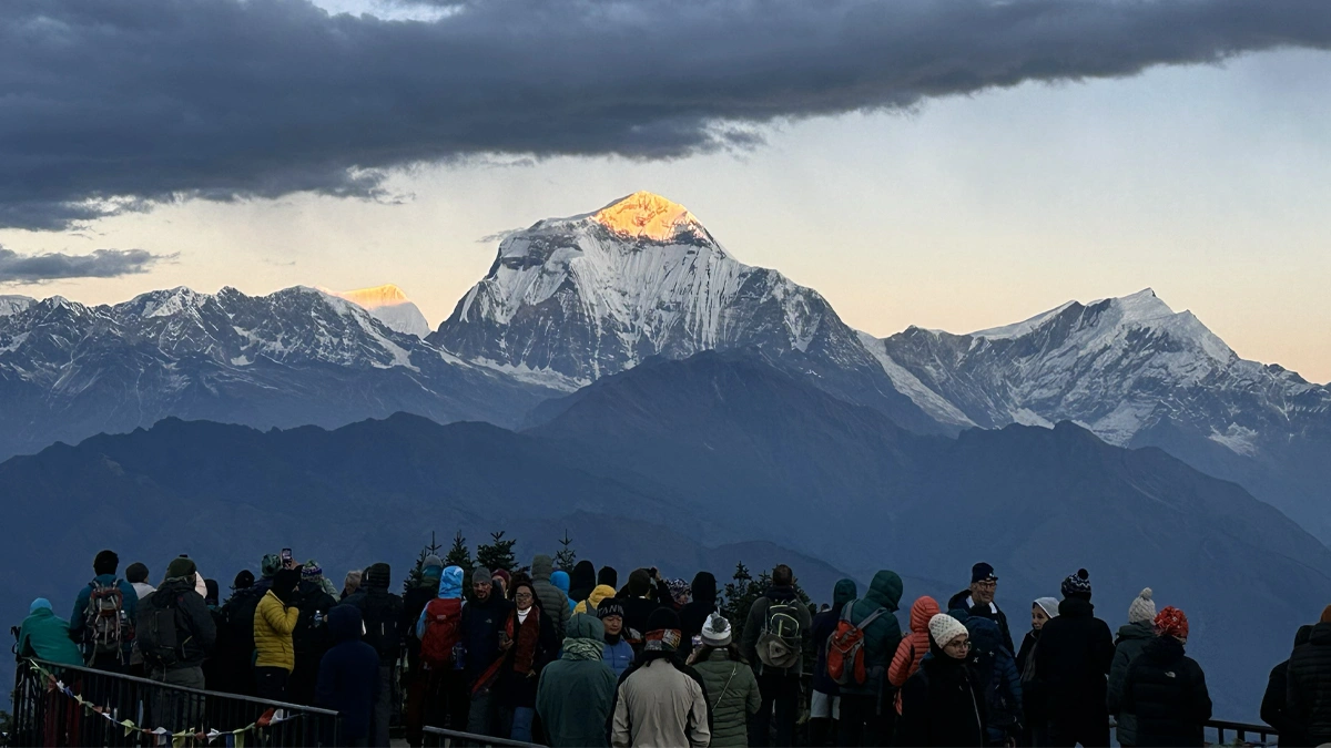 Child and parent watching sunrise over Dhaulagiri and Annapurna South from Poon Hill viewpoint